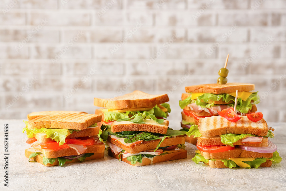 Tasty sandwiches on light background