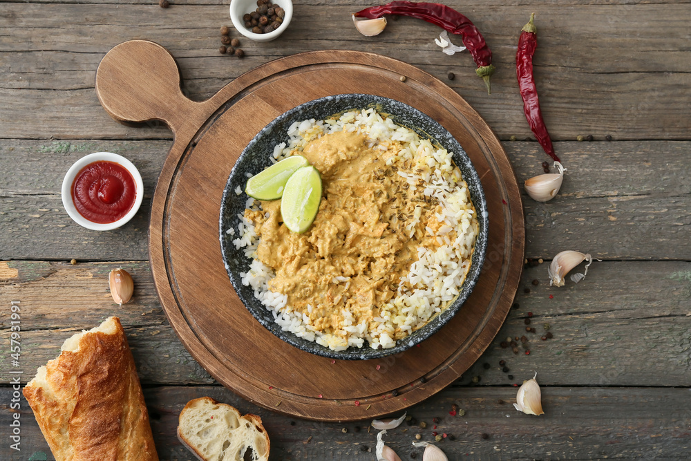 Composition with tasty chicken curry on wooden background