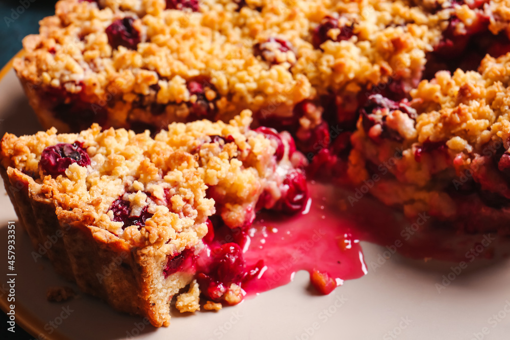 Plate with tasty cherry pie on table, closeup
