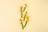 Fototapeta Tulipany - Fresh zucchini with flowers on color background