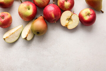 Wall Mural - Ripe pears and apples on light background