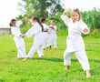 © JackF - Little girl make karate exercises in summer park