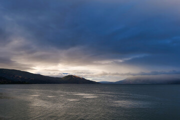 Wall Mural - Storm over mountains at clear lake California 