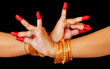 Female classical dancer hands on black background showing 