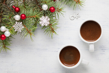 Sticker - Two cups of coffee and  spruce branch with Christmas decorations on old wooden shabby background.