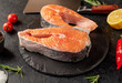 raw salmon steak on stone background