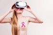 Girl in bra pink cancer ribbon and vr box