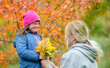 © Ermolaev Alexandr - Mother and little girl with special needs have a fun in autumn park
