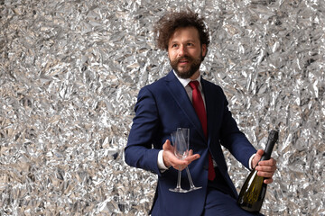 Sticker - handsome businessman holding a champagne bottle and glasses