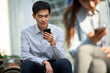 © imtmphoto - young asian business man using cellphone outdoors