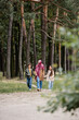 © LIGHTFIELD STUDIOS - Arabian mother walking with kids in park during autumn