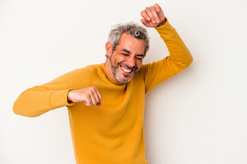 Middle age caucasian man isolated on white background  celebrating a special day, jumps and raise arms with energy.
