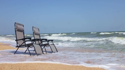 Wall Mural - two lounge sun chairs on the sea beach