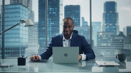 Poster - Portrait of Successful Black Businessman Working on Laptop Computer in His Big City Office. Smiling Digital Entrepreneur does Data Analysis for e-Commerce Strategy assessment. Zoom In Front View