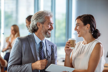 male and female colleagues looking at tablet pc. business people are working at desk. image of two c