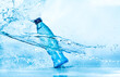 Leinwanddruck Bild Bottle of water splash