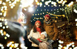 © Syda Productions - family, winter holidays and celebration concept - happy mother, father and little daughter at christmas market on town hall square in tallinn, estonia