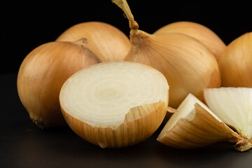 Wall Mural - Whole and haft group pile ingredient of fresh onion  group isolated on black background