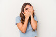 © Asier - Young caucasian woman isolated on white background blink through fingers frightened and nervous.