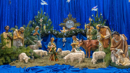 Christmas nativity scene with baby Jesus, Mary and Joseph in the manger with sheeps. Christmas event.