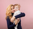 © rubchikova - mother and child isolated on pink.