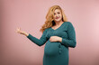 © rubchikova - Portrait of a smiling pregnant woman in a green dress