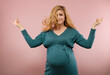 © rubchikova - Portrait of a smiling pregnant woman in a green dress