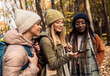 © Zoran Zeremski - Three female friends having fun and enjoying hiking in forest.