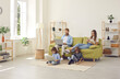 © Studio Romantic - Family sitting in cozy spacious Scandinavian livingroom with wireless Internet connection at home, kids watching video on laptop and tablet, parents using their own devices. People, technology concept