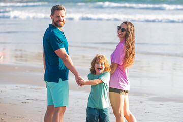 Sticker - Family walk along sea beach. Happy parents with child playing on beach. Spending summer time in nature.