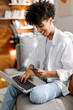 © (JLco) Julia Amaral - Woman making an online purchase at home