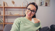 © LIGHTFIELD STUDIOS - Positive woman in eyeglasses looking at camera at home