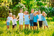 © davit85 - A group of happy children of boys and girls run in the Park on the grass on a Sunny summer day.