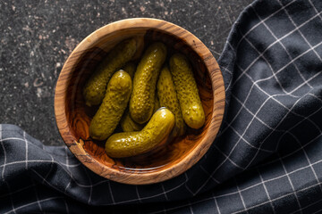 Wall Mural - Small pickles. Marinated pickled cucumbers in wooden bowl.