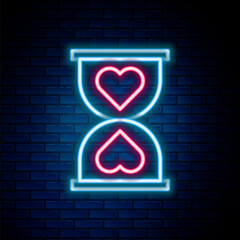 Poster - glowing neon line heart in the center old hourglass icon isolated on brick wall background. valentin