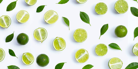  Fresh limes with green leaves on white background.