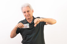 Elderly Man Holding 200 Brazilian Reais Banknote With Gesture In Use Of The Great Currency Devaluation