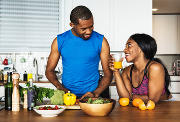 Wall Mural - Black couple cooking healthy food in the kitchen