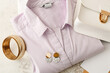 Female shirt and stylish accessories on table