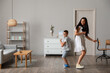 © Pixel-Shot - Young woman and her little son dancing at home