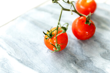 Wall Mural - Fresh tomatoes on a marble background