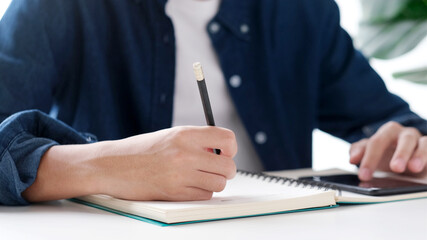 Wall Mural - online study, man hand using mobile phone for digital home study class, adult male student doing les