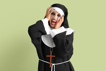 Woman dressed for Halloween as nun on color background