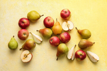 Ripe pears and apples on color background