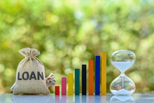 Personal Loan, Non-performing Assets, Financial Concept : Loan Bag, Color Bar Graph, Hourglass On A Table, Depicts Long Term Money Borrowing Between Borrower And Lender Secured By A Promissory Note