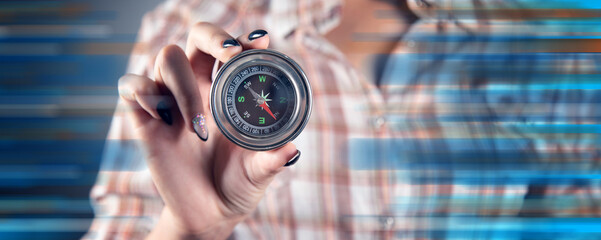 Wall Mural - A women holds a compass in hand