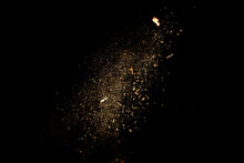 Dust And Wood Chips On A Black Background. Dirt Particles Fly In The Air. Layout For Design. Some Dust Particles Are Blurred To Transmit The Effect Of Motion.