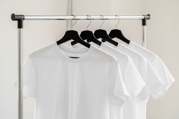 Wall Mural - Row of white t-shirts on hangers on rack