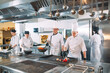 © davit85 - Five chefs wearing uniforms posing in a kitchen .