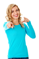 Cheerful Polish woman in blue clothes pointing at you isolated on white backgrou